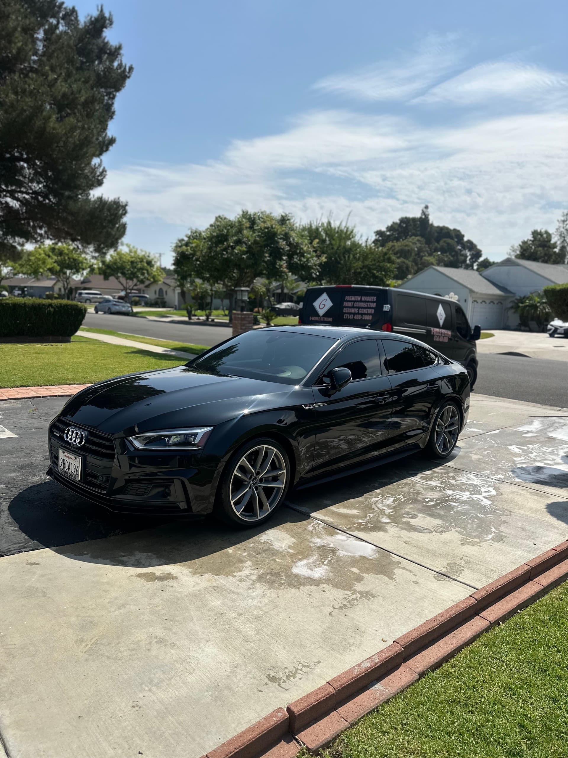 Black Audi S5 freshly detailed on driveway with G Mobile van