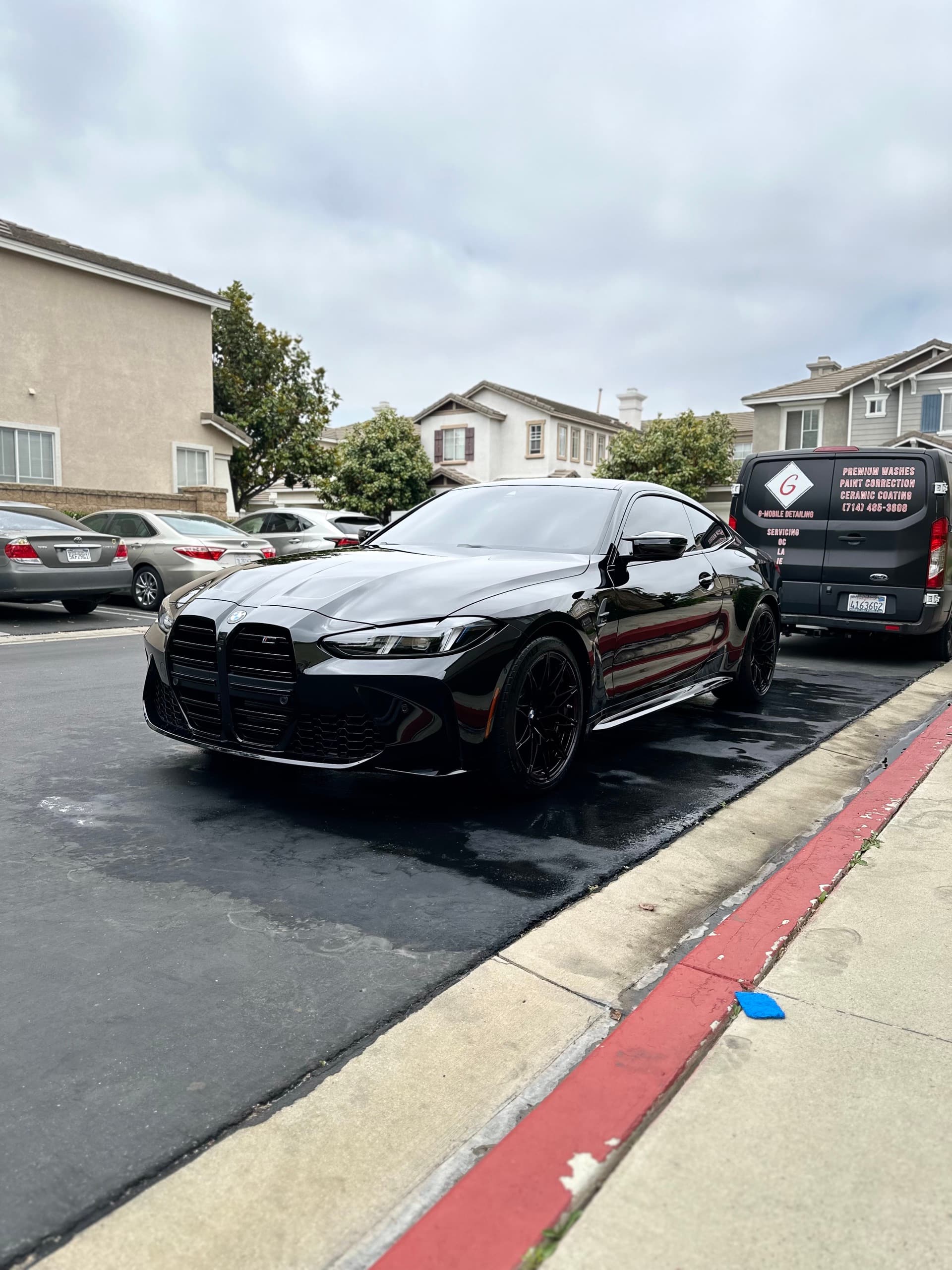Black BMW M4 freshly detailed with G Mobile Detailing van