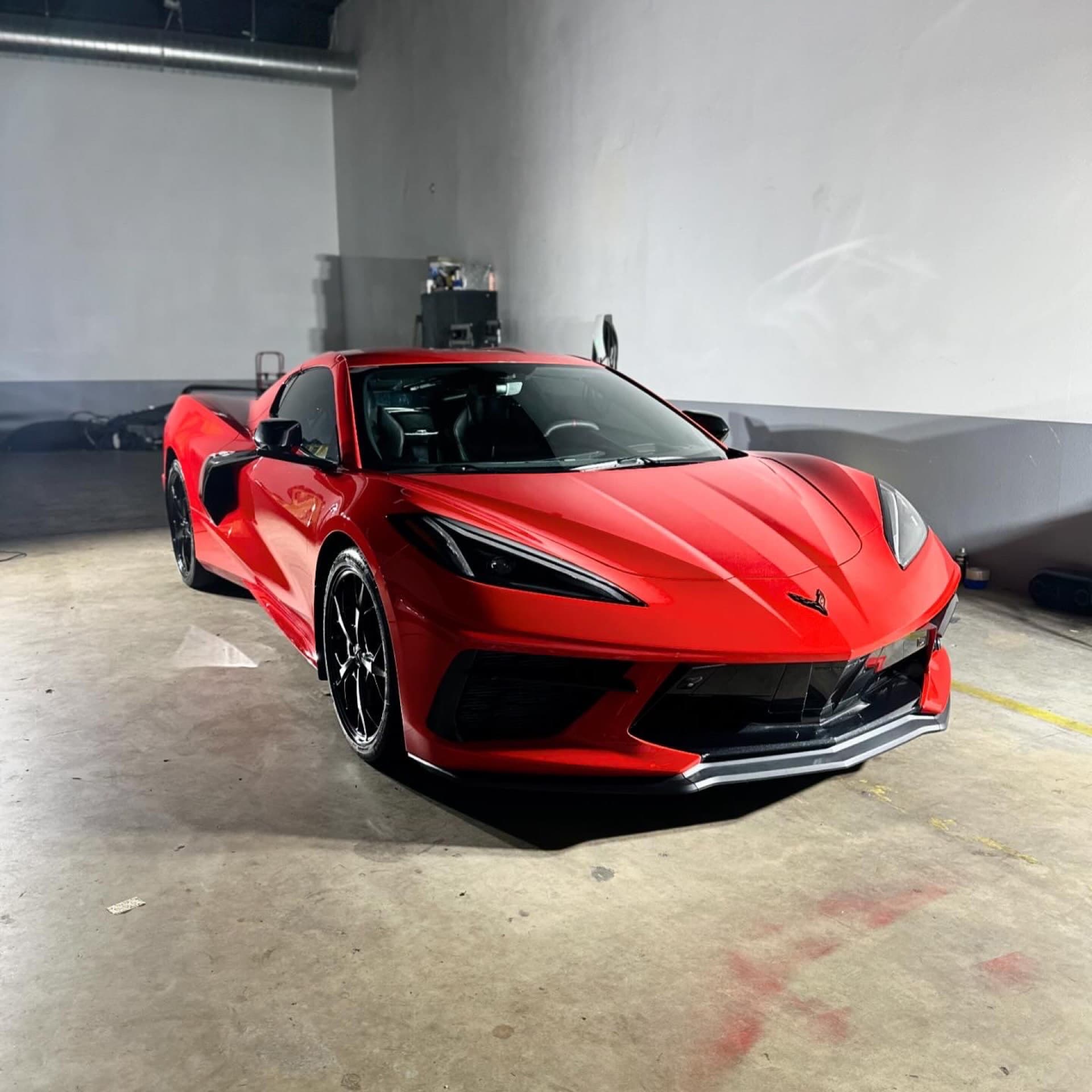 Red Corvette C8 detailed in studio garage