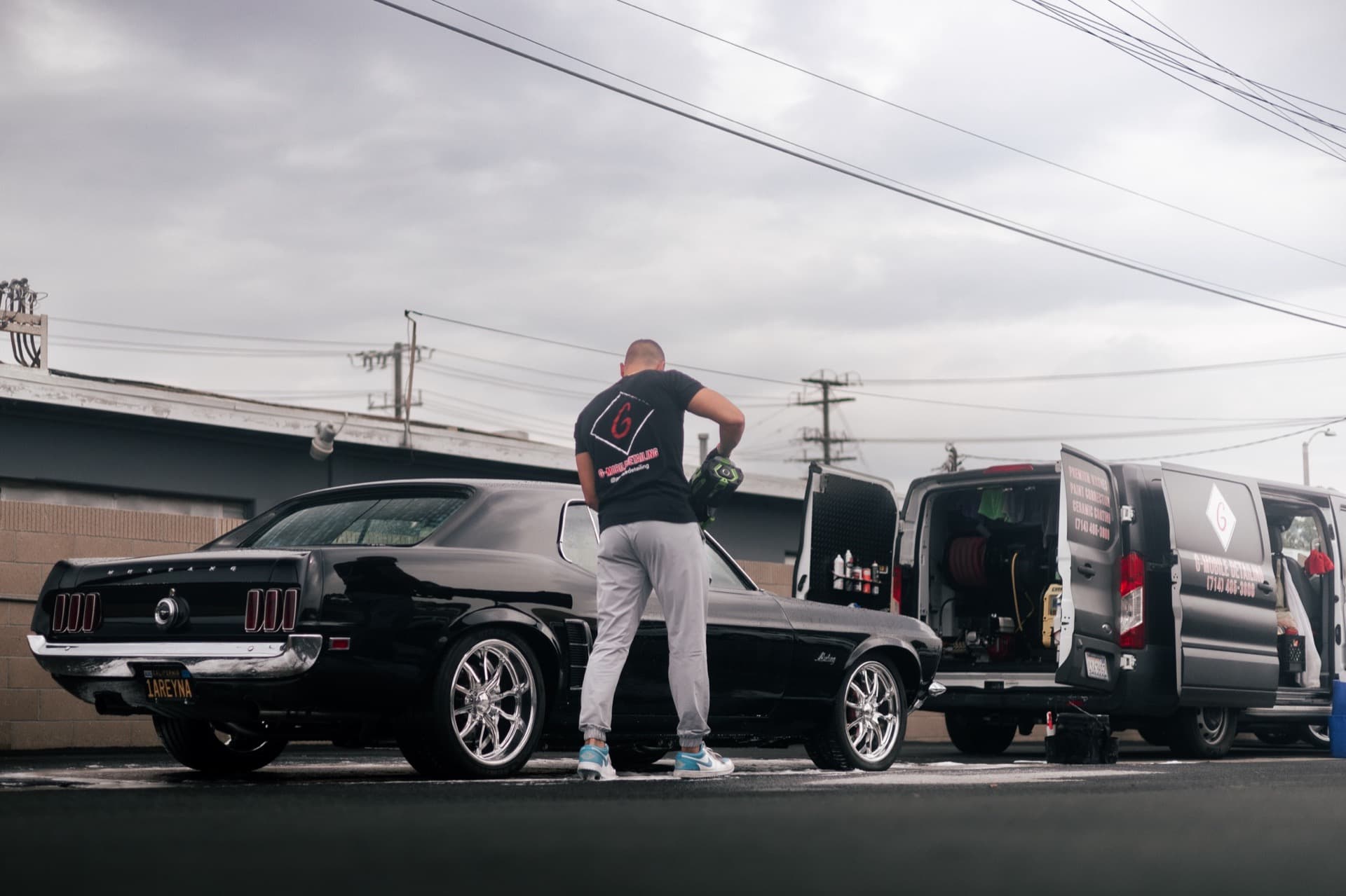 Fady from G Mobile Detailing working on a classic Ford Mustang with mobile detailing van in Orange County