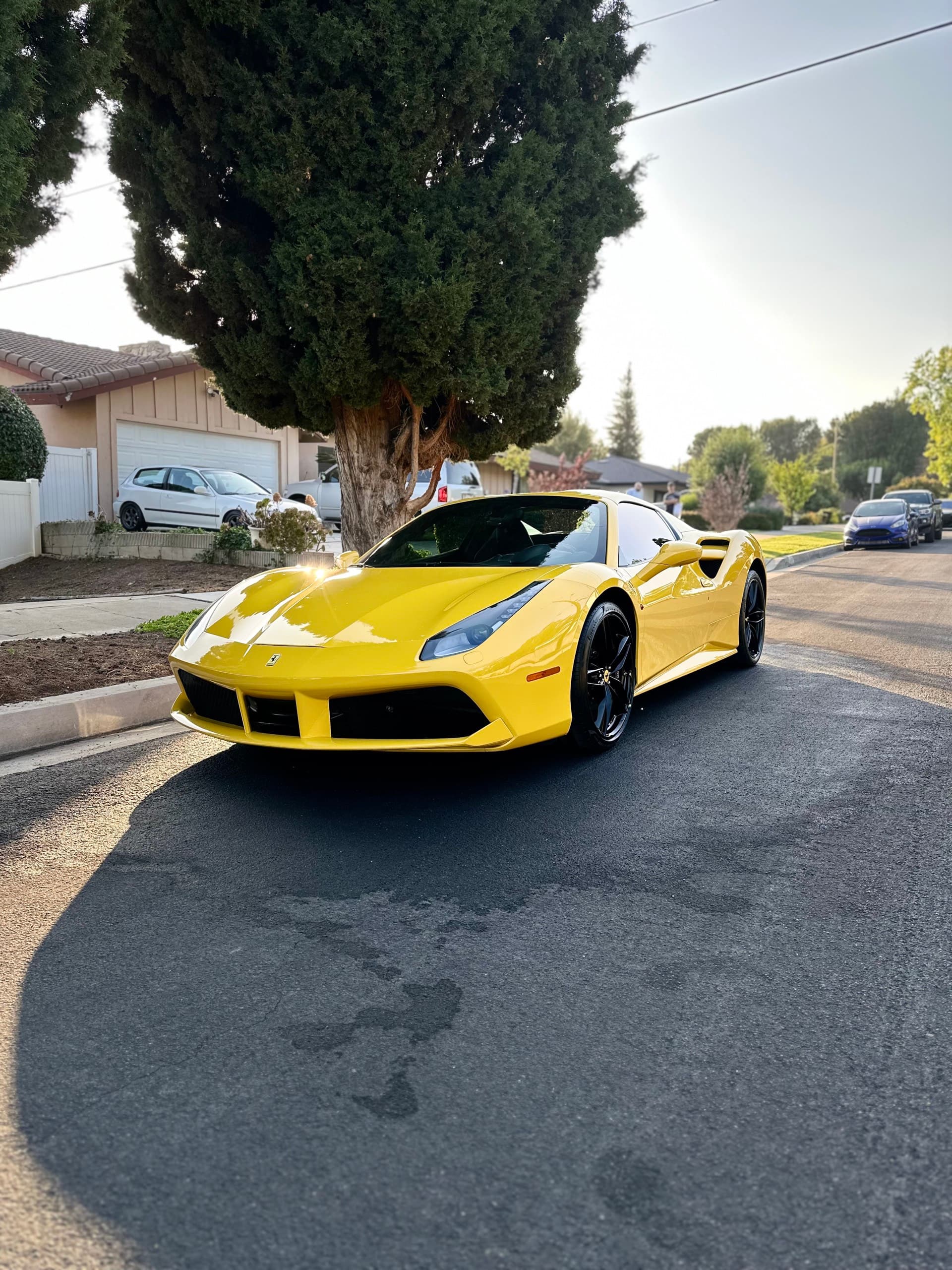 Yellow Ferrari 488 detailed on driveway in Orange County