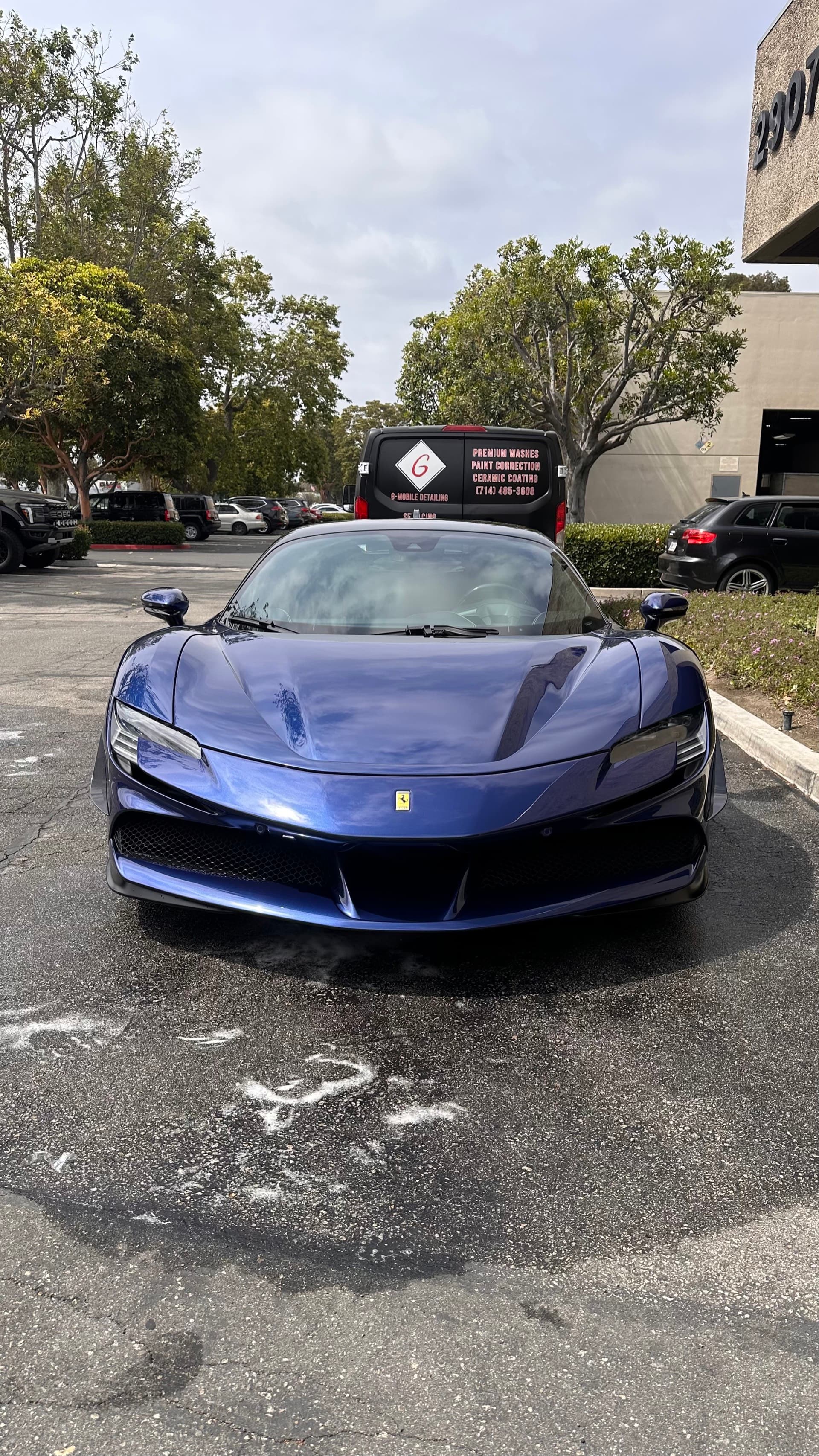 Blue Ferrari SF90 Stradale detailed with G Mobile Detailing van