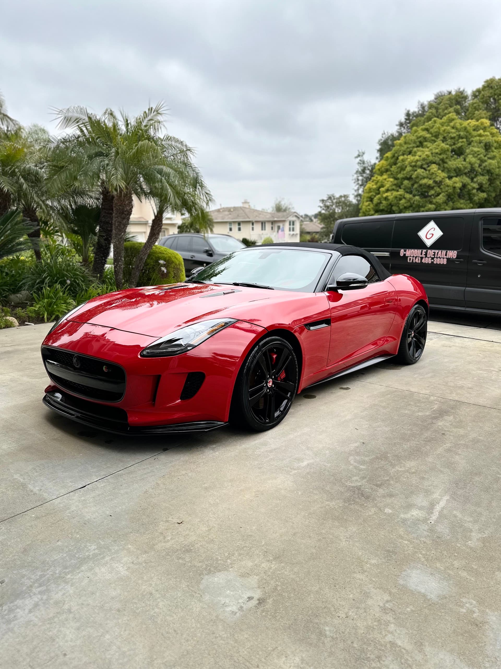 Red Jaguar F-Type detailed in driveway with G Mobile van