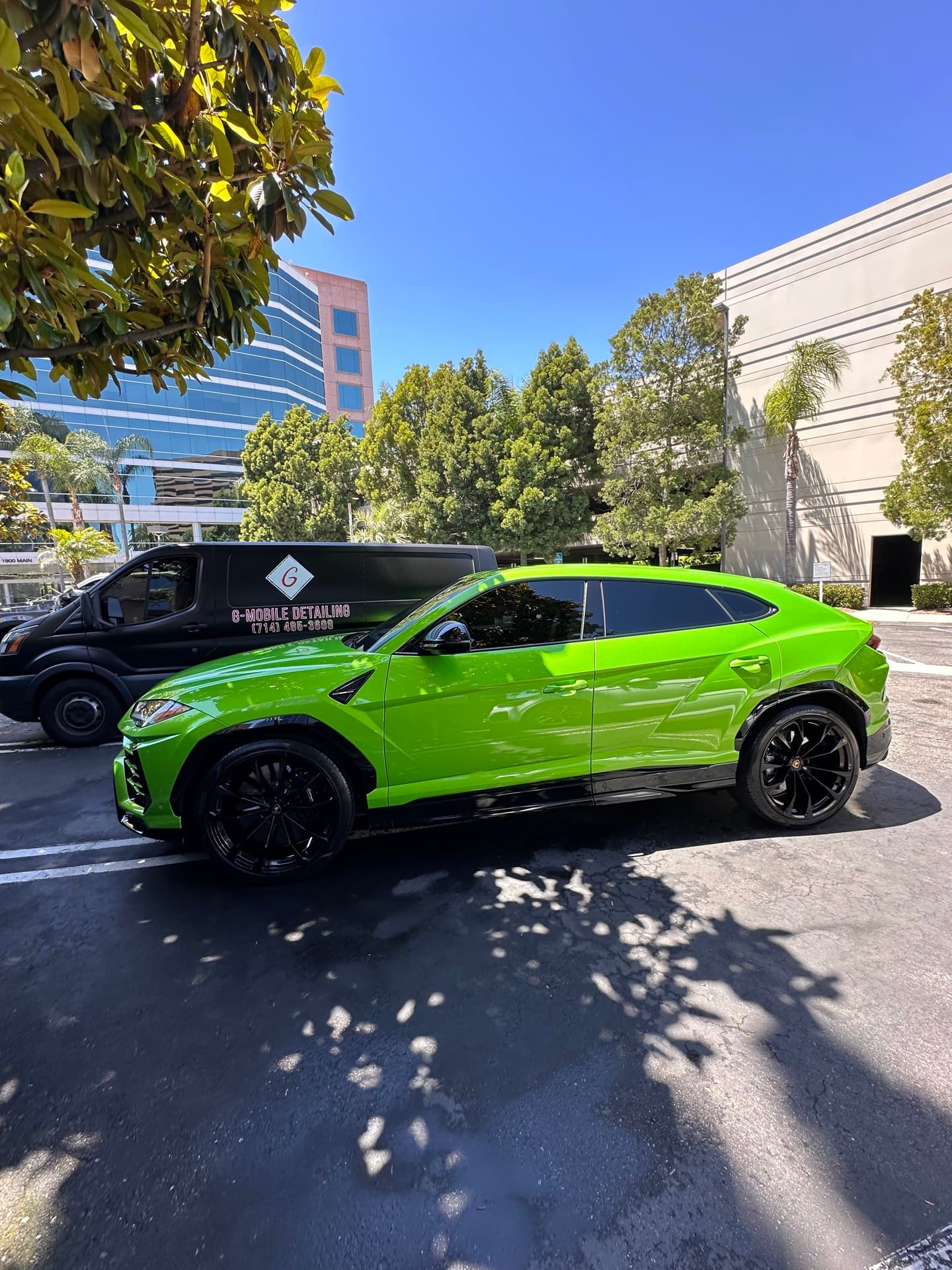 Green Lamborghini Urus with G Mobile Detailing van