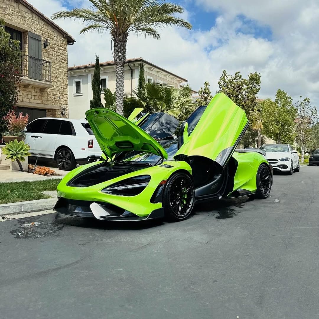 Green McLaren 765LT with doors up in the driveway, detailed by G Mobile Detailing in Orange County