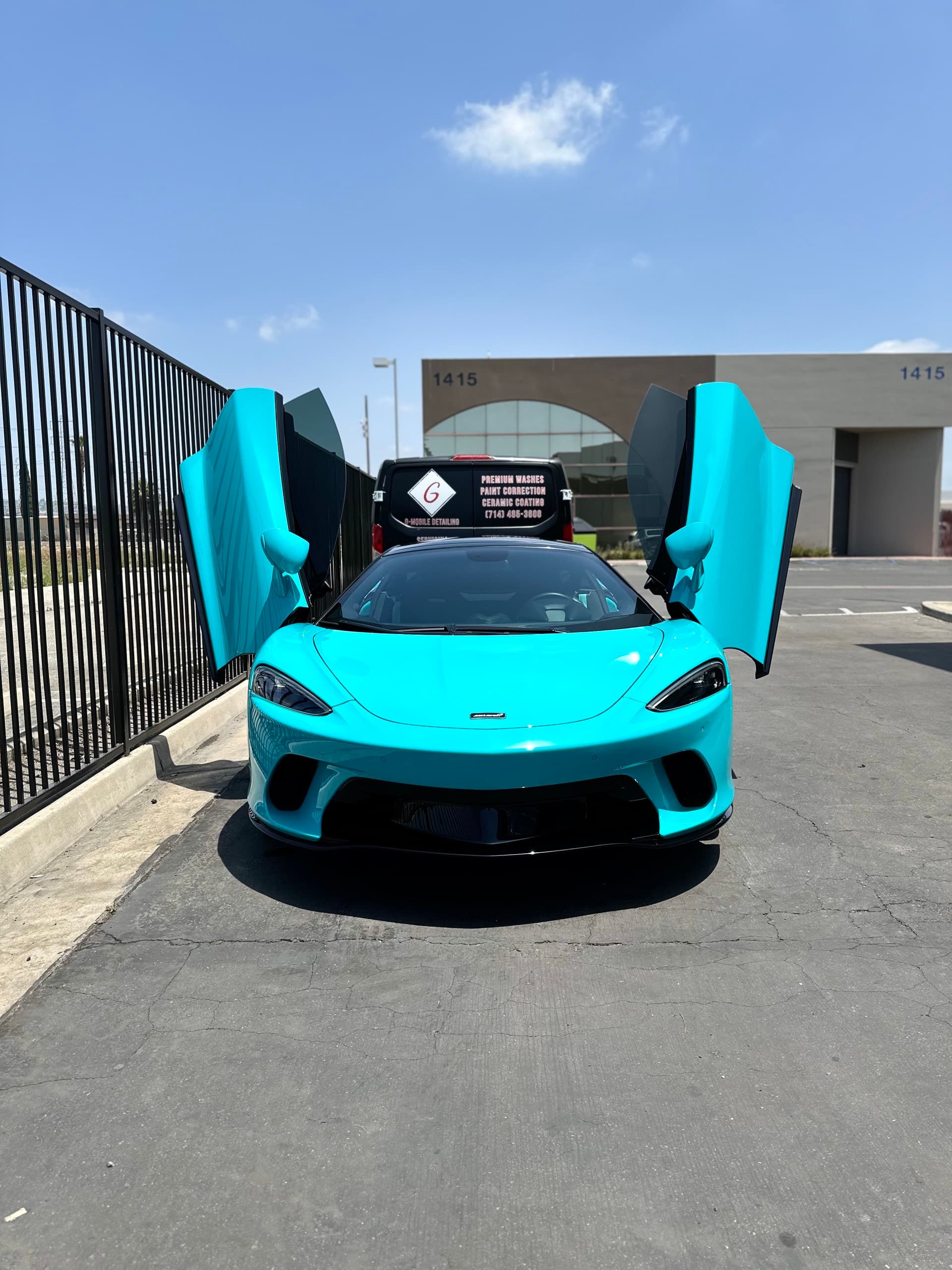 Turquoise McLaren GT with doors up after detailing in Orange County