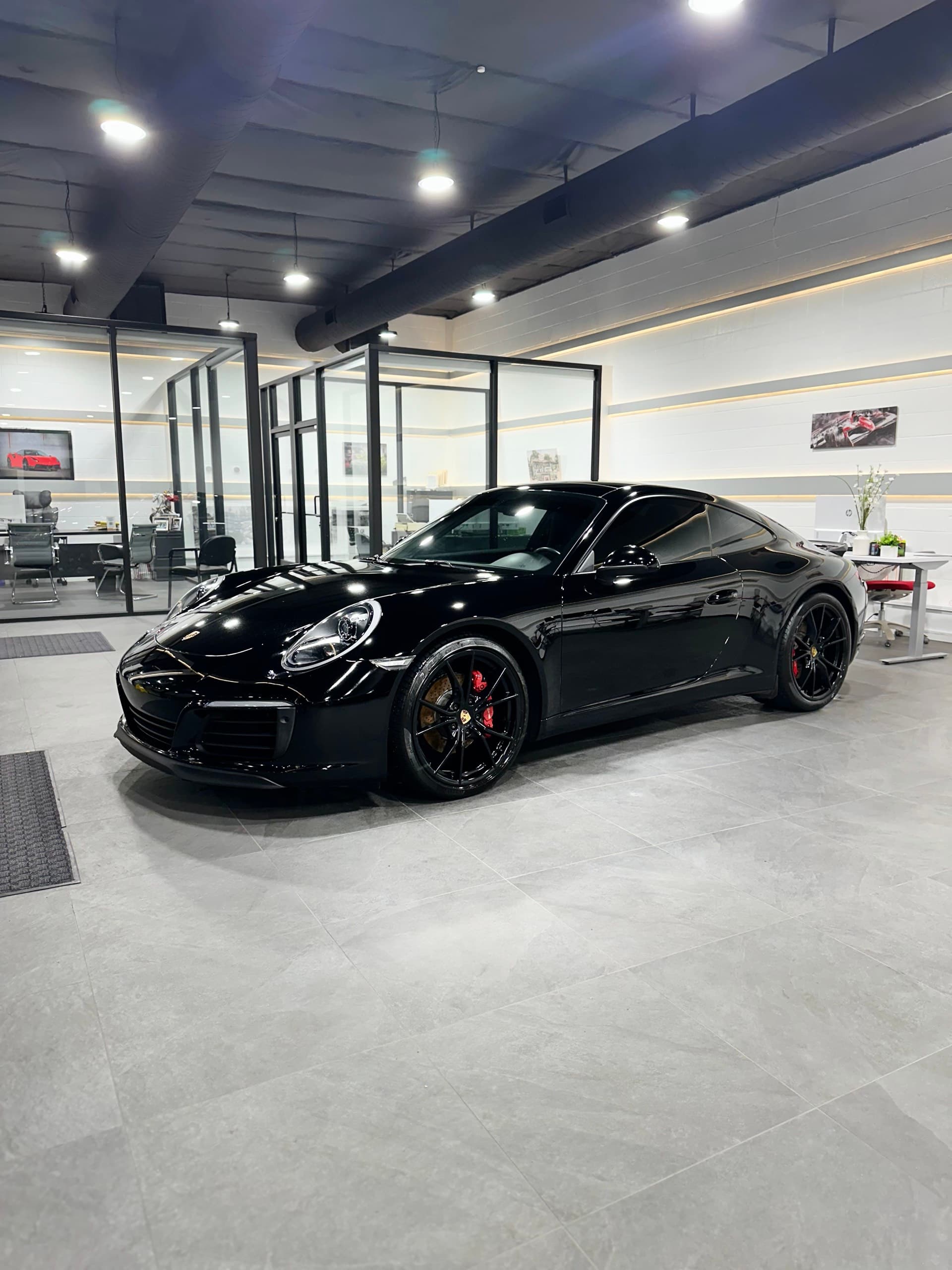 Black Porsche 911 showroom glossy finish after full detail