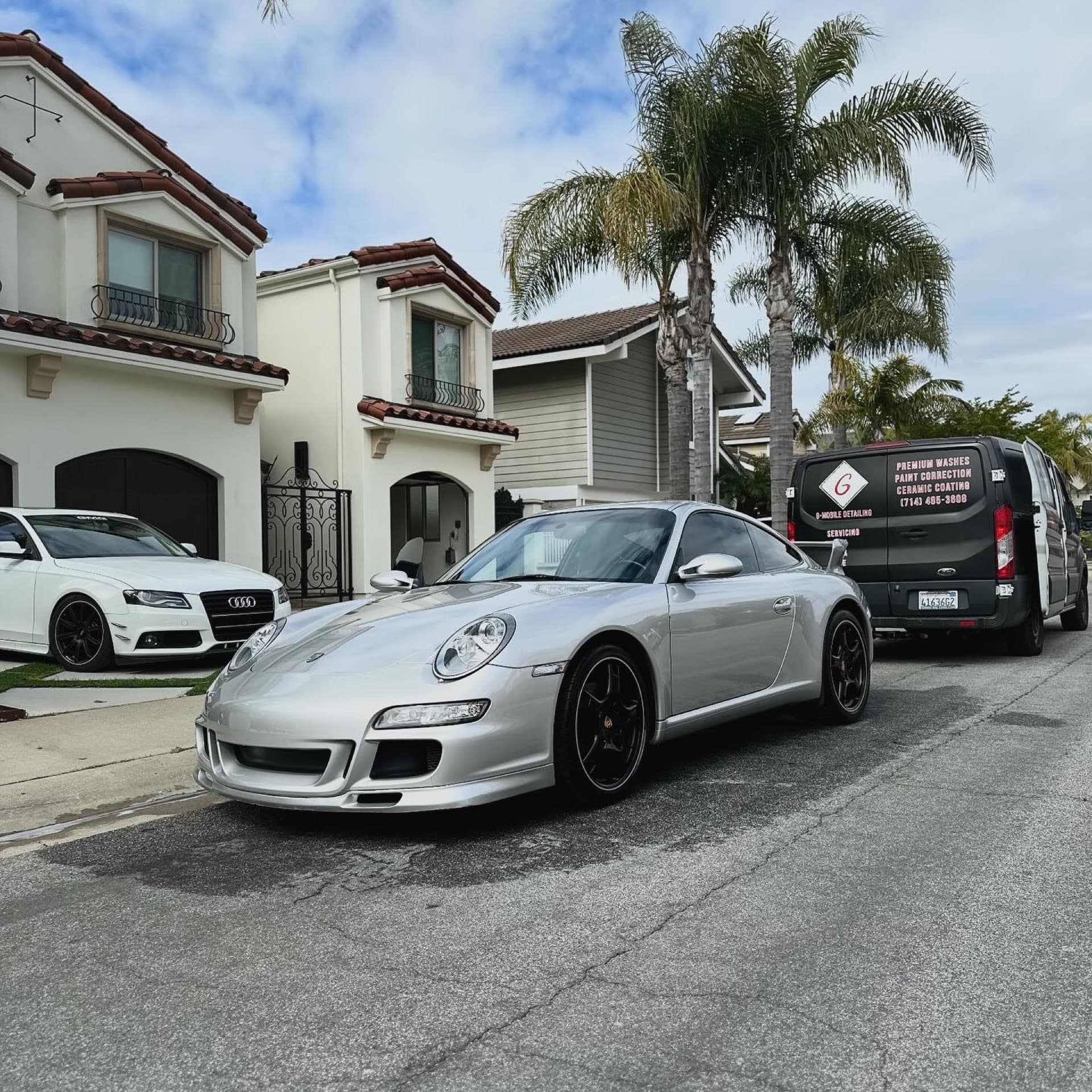 Silver Porsche 997 on driveway with G Mobile van in Orange County