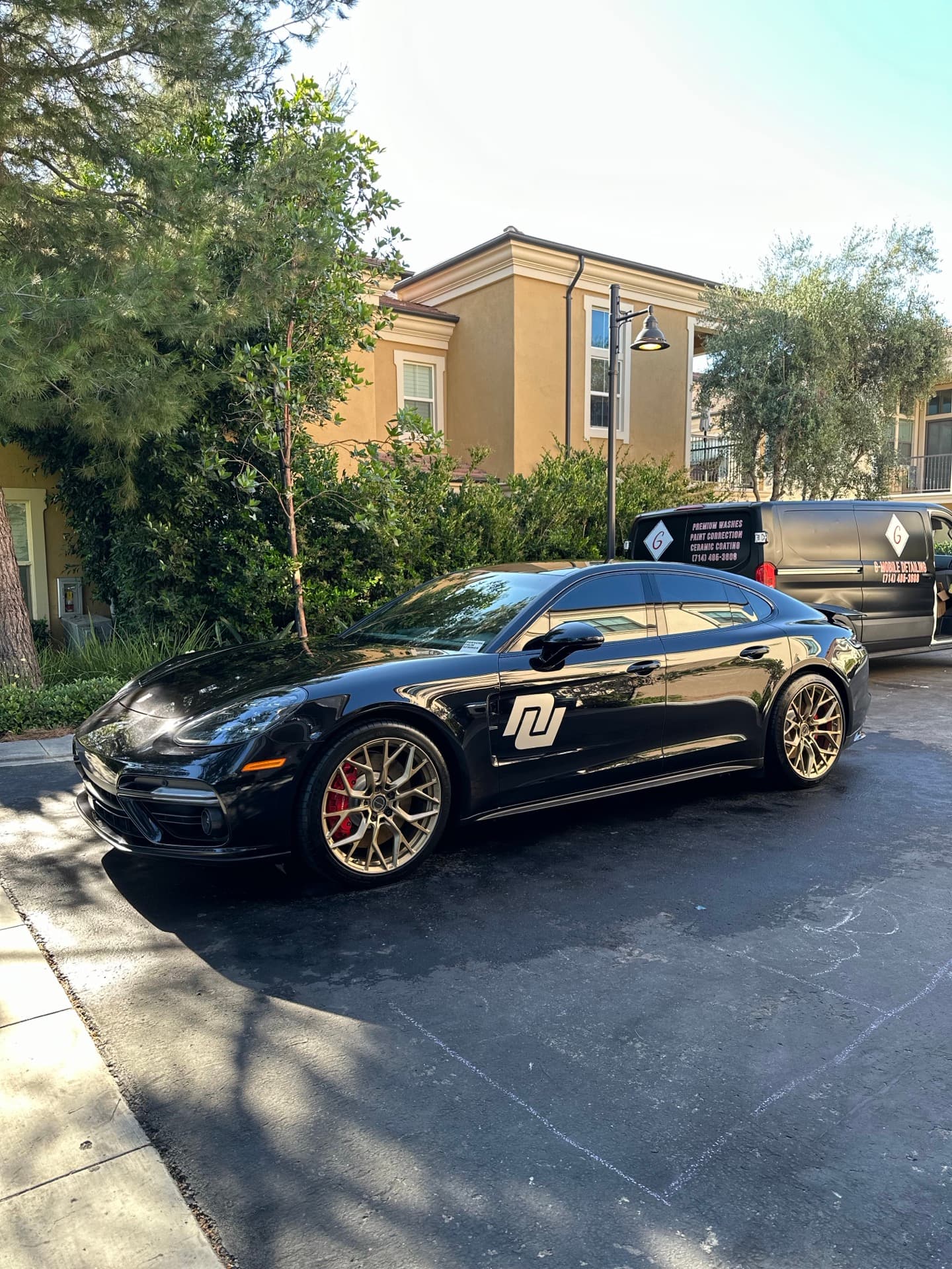 Blue Porsche Panamera GTS mobile detail on driveway in Orange County