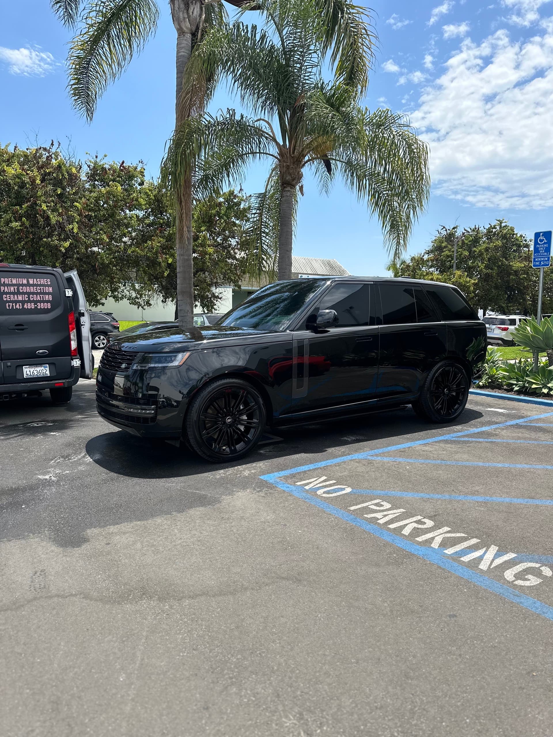 Black Range Rover mobile detail with palm trees in Orange County