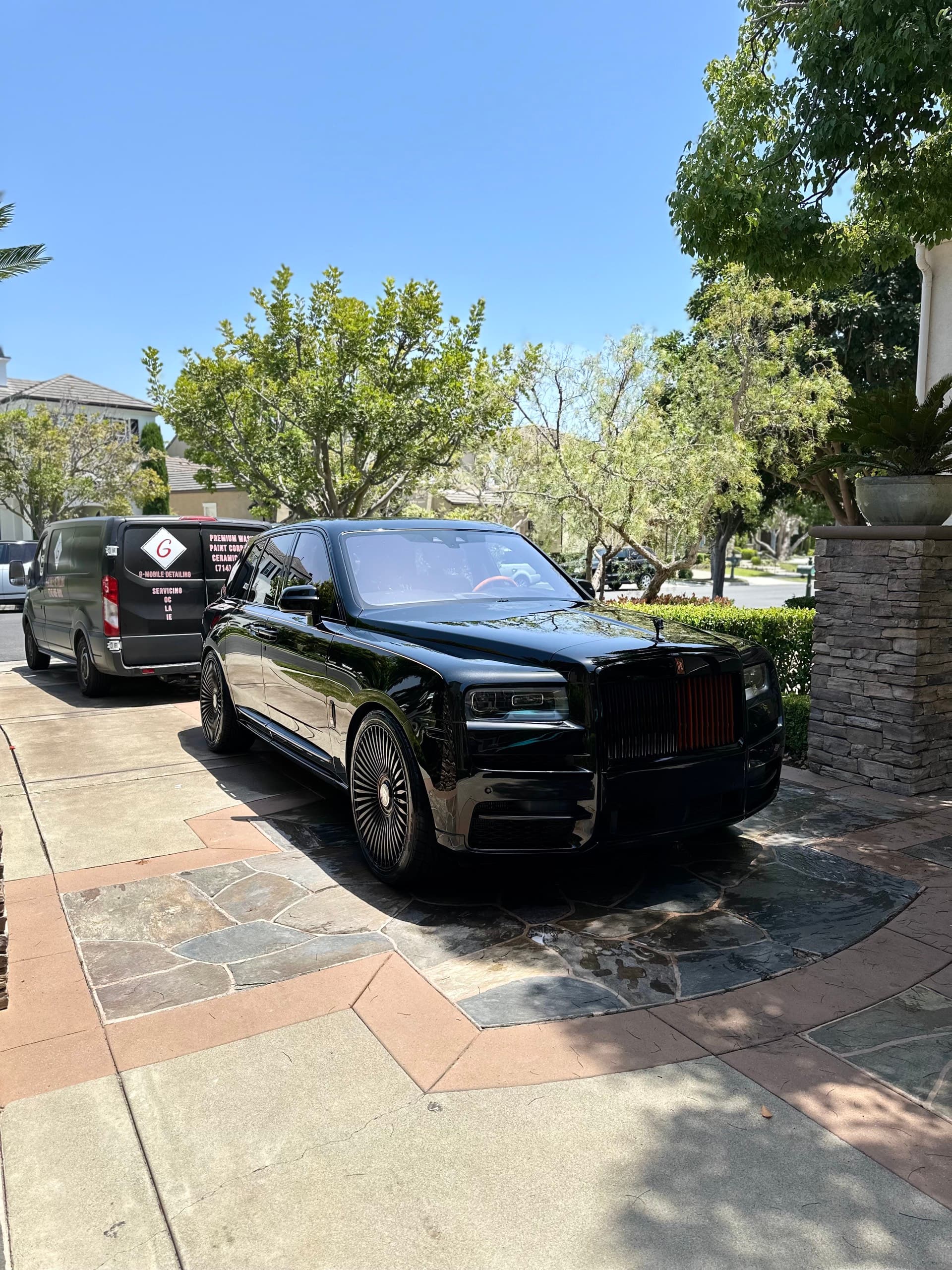 Black Rolls Royce Cullinan at mansion with G Mobile Detailing van